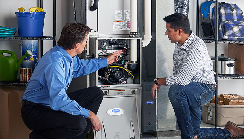 HVAC technician evaluating a furnace for repair or replacement in Peoria