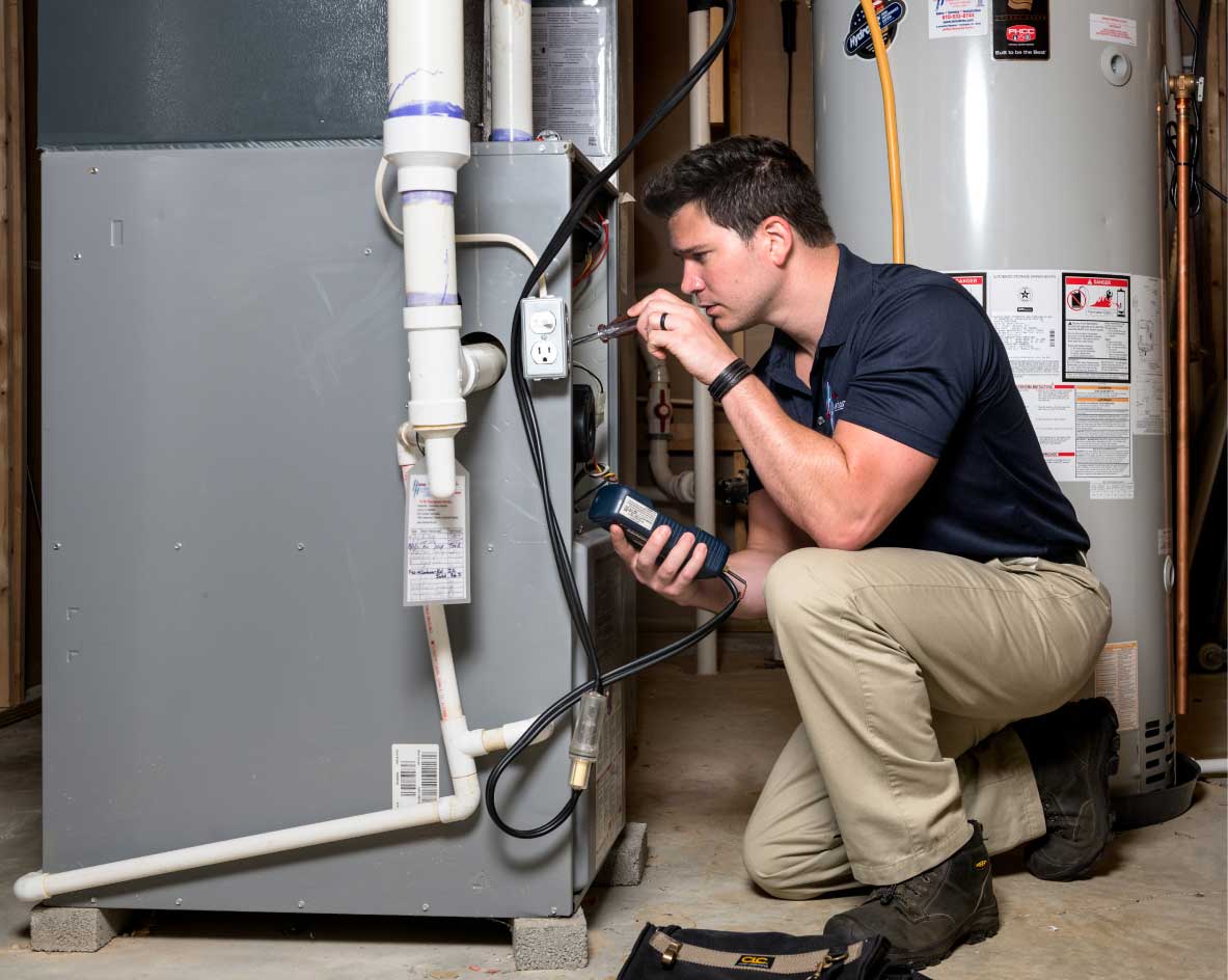 HVAC technician performing a furnace tune-up in Peoria