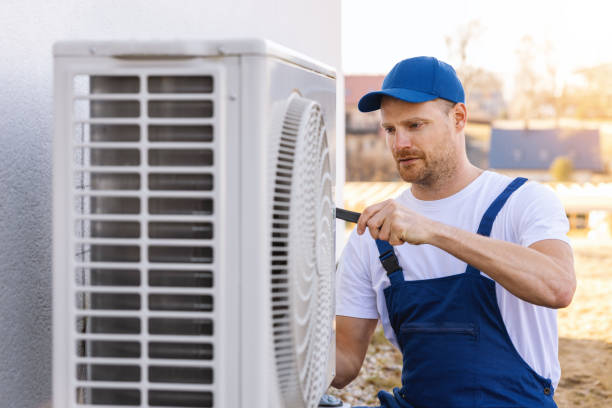 HVAC technician servicing an outdoor air conditioning unit in Peoria