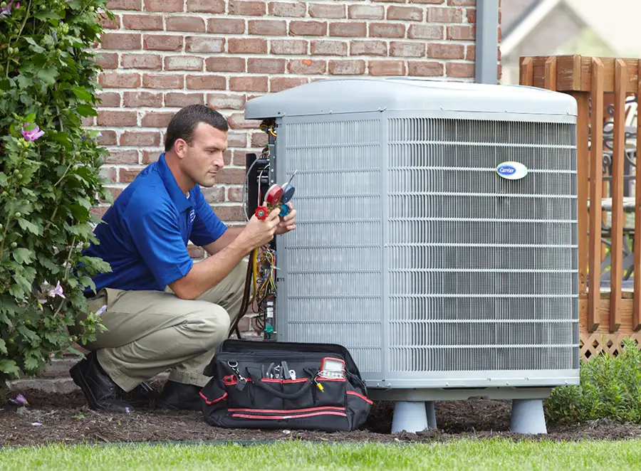 HVAC technician inspecting an outdoor air conditioning unit in Peoria